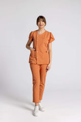 Model wearing Costum Premium Elastic Sofia in orange, featuring elegant buttons and chic ruffled sleeves for professional style.
